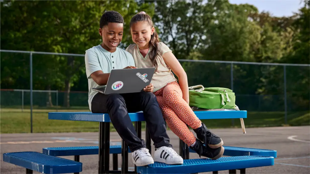 Students looking at a laptop for online learning