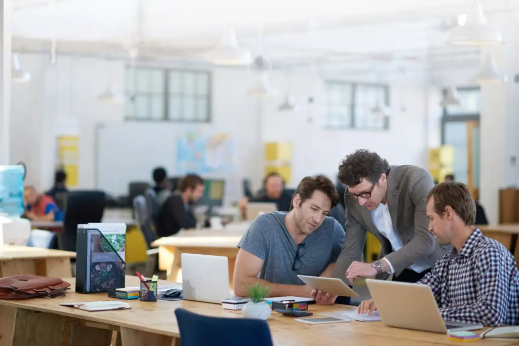 Image of employees utilizing business internet during meetings for fast and reliable business connectivity.