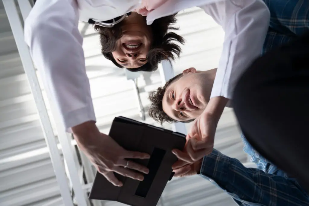 Workers make call using tablet with Comcast Business Mobile