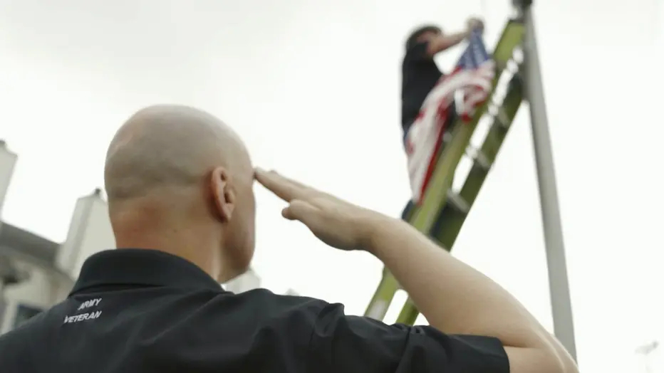 Comcast employees participate in Operation Old Glory, a flag replacement program