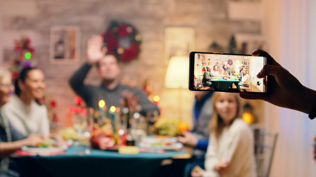 Tablet showing virtual holiday gathering with family connecting online while sharing Black Friday savings tips.